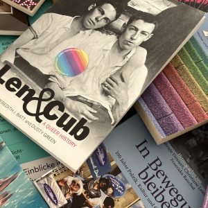bunte Magazine und Bücher zum Thema LQBTIQ* liegen verteilt auf einem Tisch