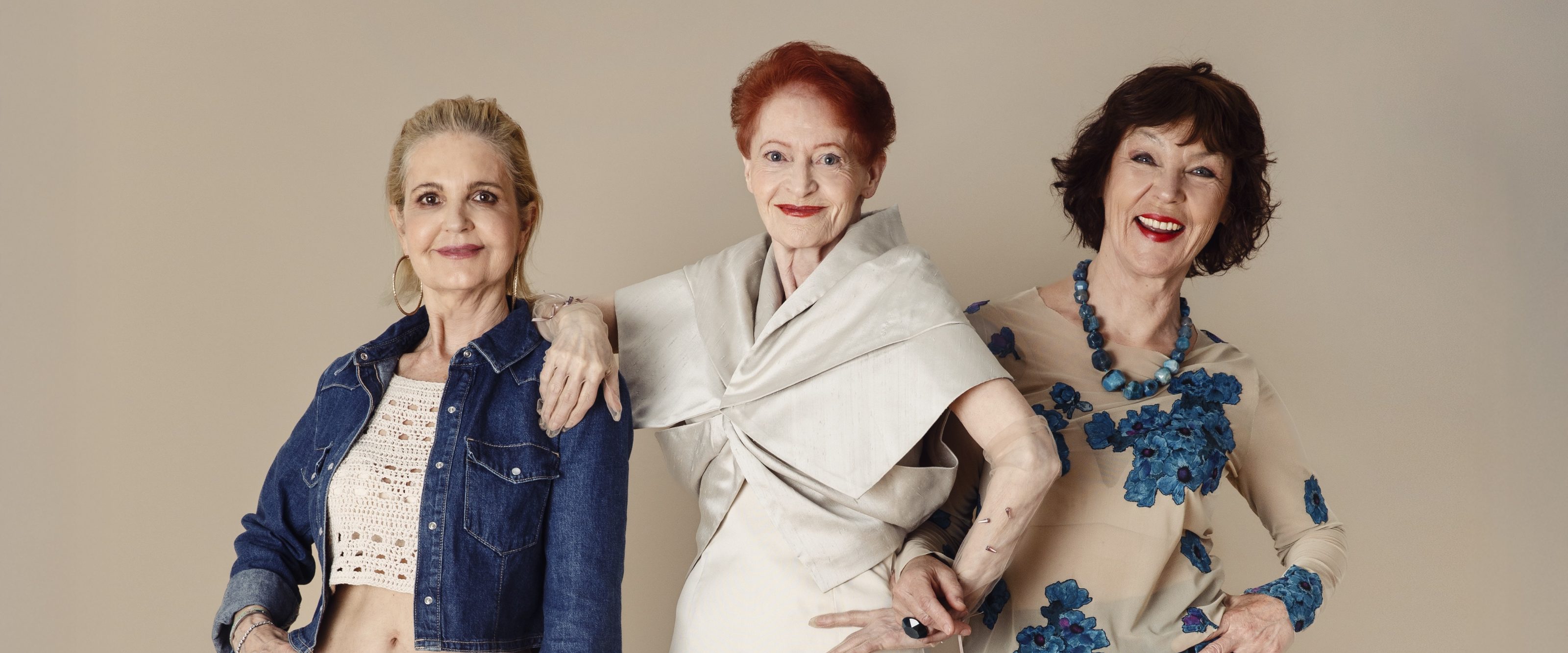 Drei Seniorinnen posen in aufregenden Outfits.